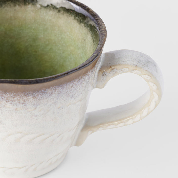 Lime green glazed mug with artisan texture and handcrafted details, perfect for enjoying your favorite beverages.