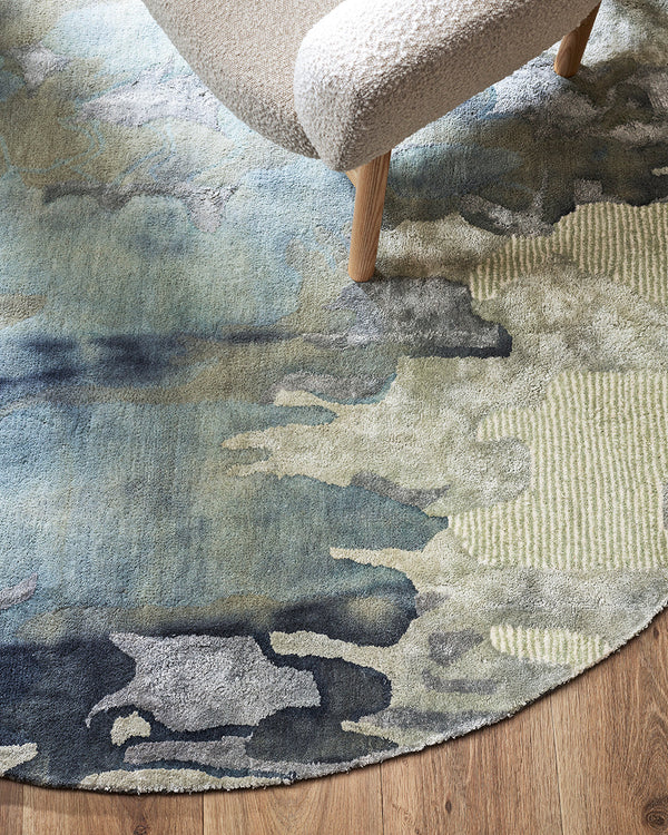 Cape Brett Round Floor Rug Add a stunning focal point to your space with the aquatic inspired design of Cape Brett. Beautiful depth of colour is achieved through a specialised over-dyeing process applied to a handtufted base. The time-consuming nature of