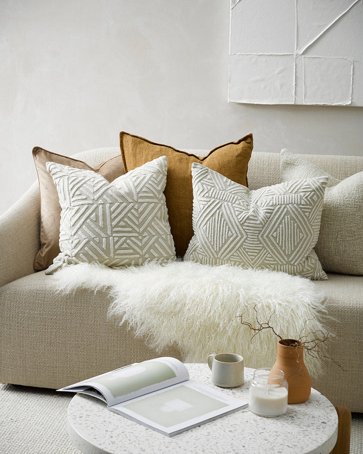 Cassius Cushion Tufted embroidery on a natural base forms the texture on this relaxed and expressive cushion. Centred on a serene colour palette of ecru and taupe, the subtly tribal surface design looks great paired with finely woven linens in neutral and