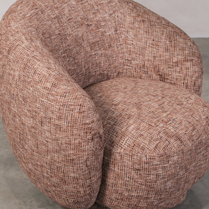 Aslan Occasional Chair Rust The Aslan Occasional Chair invites you to sink into plush comfort with its curved silhouette and soft, textured upholstery. This chair introduces a vibrant, multi-coloured fabric that adds bold personality while maintaining a r
