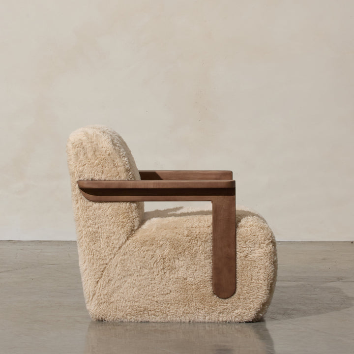 Corwin Occasional Chair Yakety Yak Our Corwin Occasional Armchair is mid-century inspired statement piece that blends sculptural elegance and grounded design. This unique upholstere chair features wooden arms that seamlessly extend into the base, eliminat