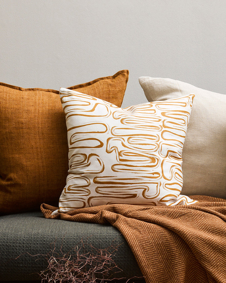 Chemin Cushion Primal and abstract, the Chemin makes a subtle, on-trend statement with organic hand-painted patterns. Warm tones of brass and ivory bring a sense of calm and serenity to spaces. Pair with sister cushion Anise and core cushions Cassia Tobac