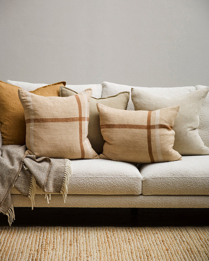 Clintock Cushion Country charm is reinterpreted for urban living in the pared-back design of our Clintock cushion. Tones of treacle, ivory and taupe are woven into an offset, oversized plaid, embodying the â€˜Rustic Retreatâ€™ trend. Comfort and quality g