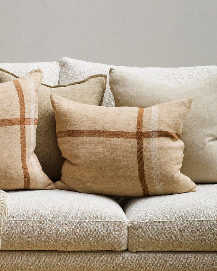 Clintock Cushion Country charm is reinterpreted for urban living in the pared-back design of our Clintock cushion. Tones of treacle, ivory and taupe are woven into an offset, oversized plaid, embodying the â€˜Rustic Retreatâ€™ trend. Comfort and quality g