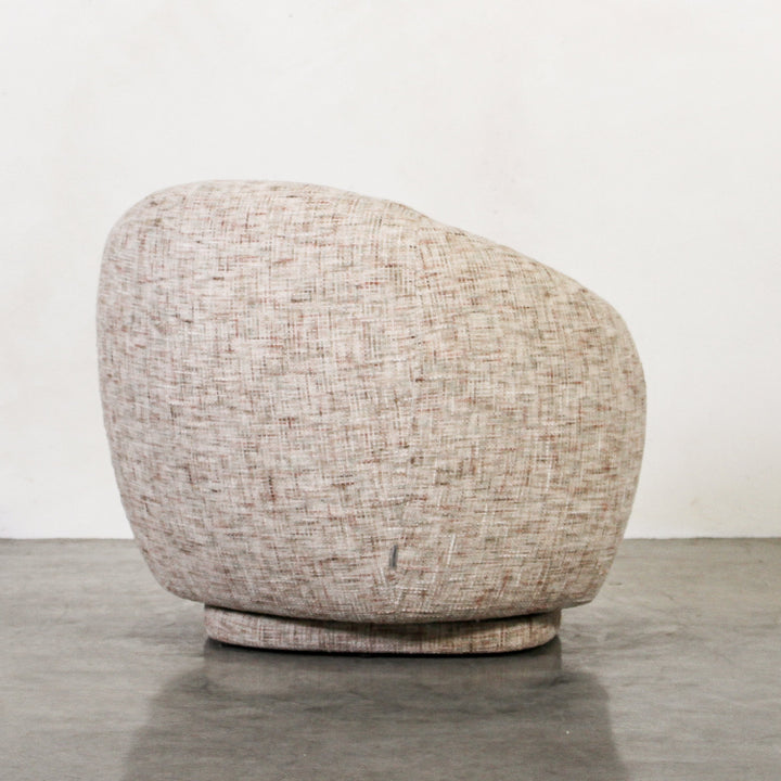 Aslan Occasional Chair Tawny The Aslan Occasional Chair invites you to sink into plush comfort with its curved silhouette and soft, textured upholstery. This chair introduces a vibrant, multi-coloured fabric that adds bold personality while maintaining a