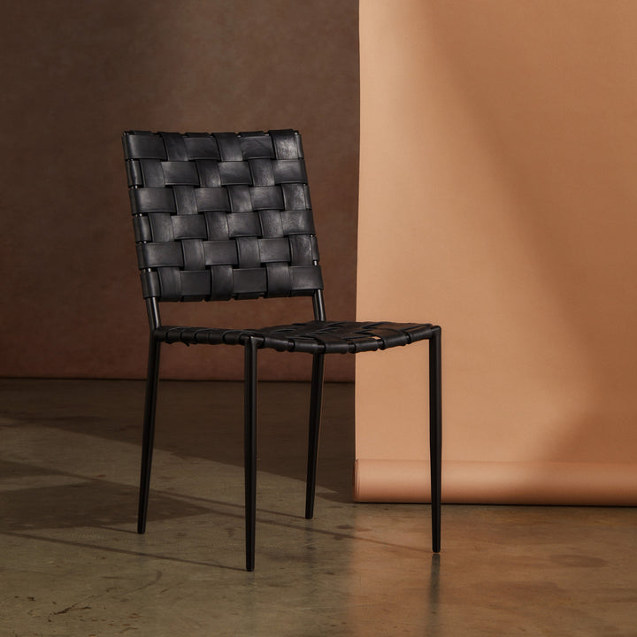 Batali Dining Chair Tan featuring woven leather strapping and sleek metal framework in a modern setting.