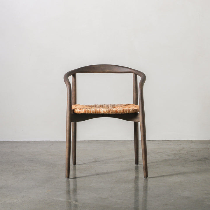 Essence Dining Chair Leaf Rope/Smoke with a gracefully arched Ash wood frame and woven leaf rope seat.