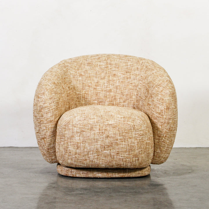 Aslan Occasional Chair Honey The Aslan Occasional Chair invites you to sink into plush comfort with its curved silhouette and soft, textured upholstery. This chair introduces a vibrant, multi-coloured fabric that adds bold personality while maintaining a