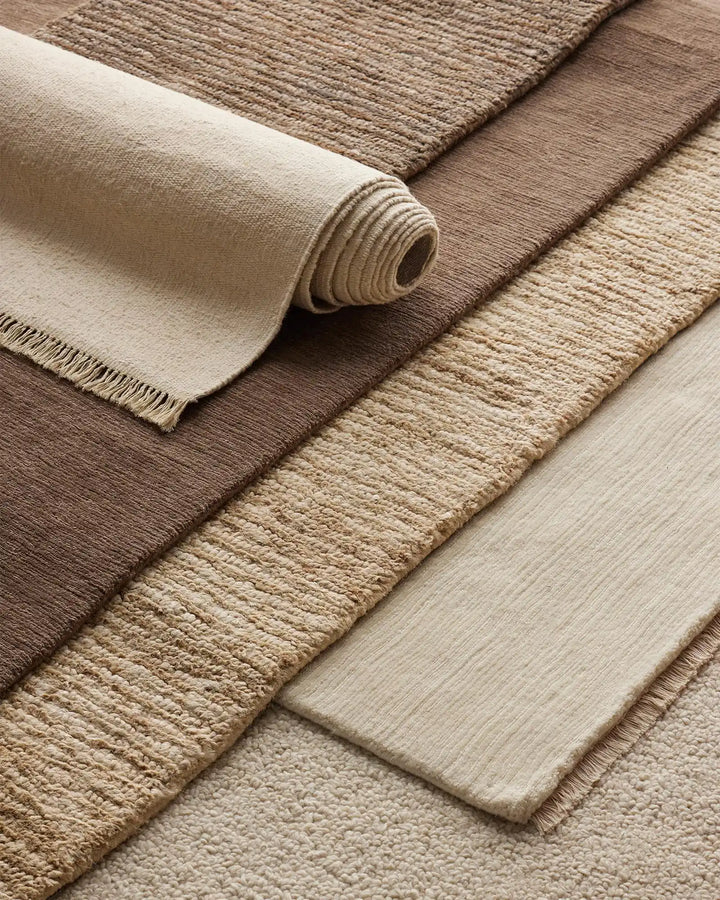 Emilio Canvas - Premium Linen Rug for Your Home Emilio Canvas is a light beige-cream rug that adds natural elegance and charm to any space with its refined design.