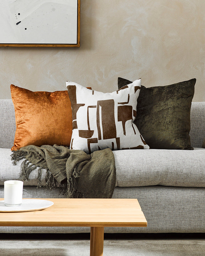 Elle Cushion Inspired by modernist forms, the design here is confident with off-beat copper shapes arranged on a pure linen base. Hand-painted by our in-house design team, this elegant and expressive cushion pairs well with brown or green-toned core produ