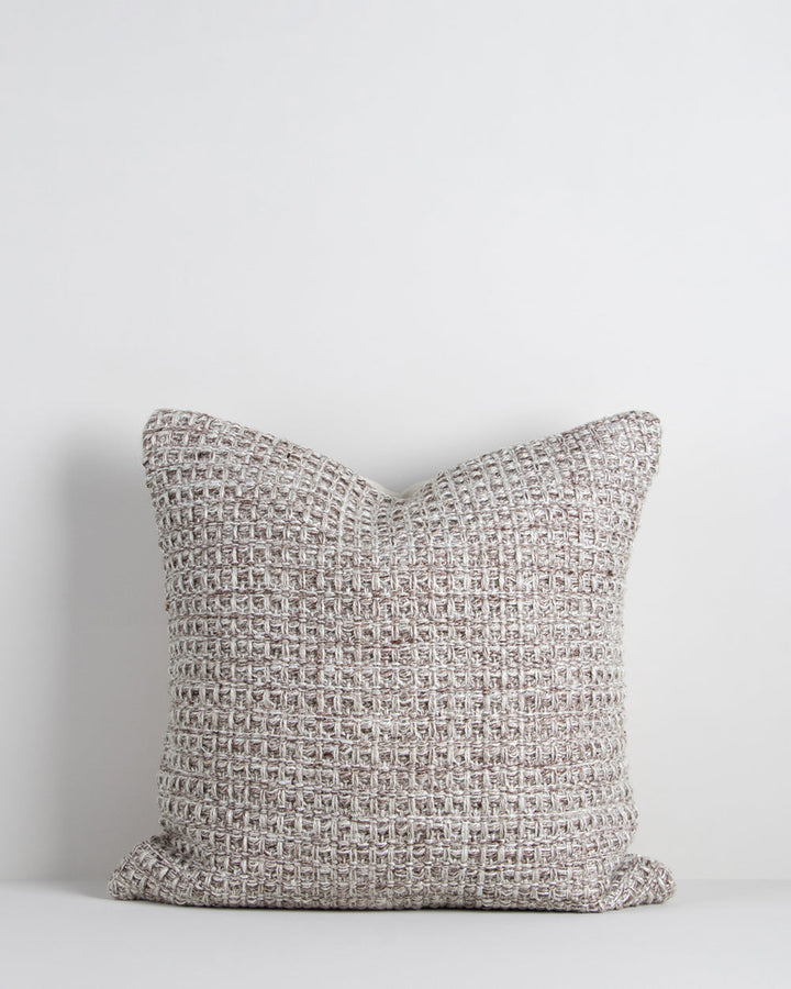 Elton Cushion A natural, artisan aesthetic is reflected in the stunning design of this outdoor cushion. Handwoven from soft PET yarn (derived from recycled plastic bottles), the Elton features a classic basketweave texture in speckled hues of cocoa, ecru