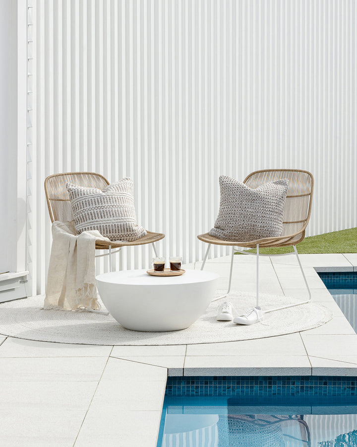 Elton Cushion A natural, artisan aesthetic is reflected in the stunning design of this outdoor cushion. Handwoven from soft PET yarn (derived from recycled plastic bottles), the Elton features a classic basketweave texture in speckled hues of cocoa, ecru