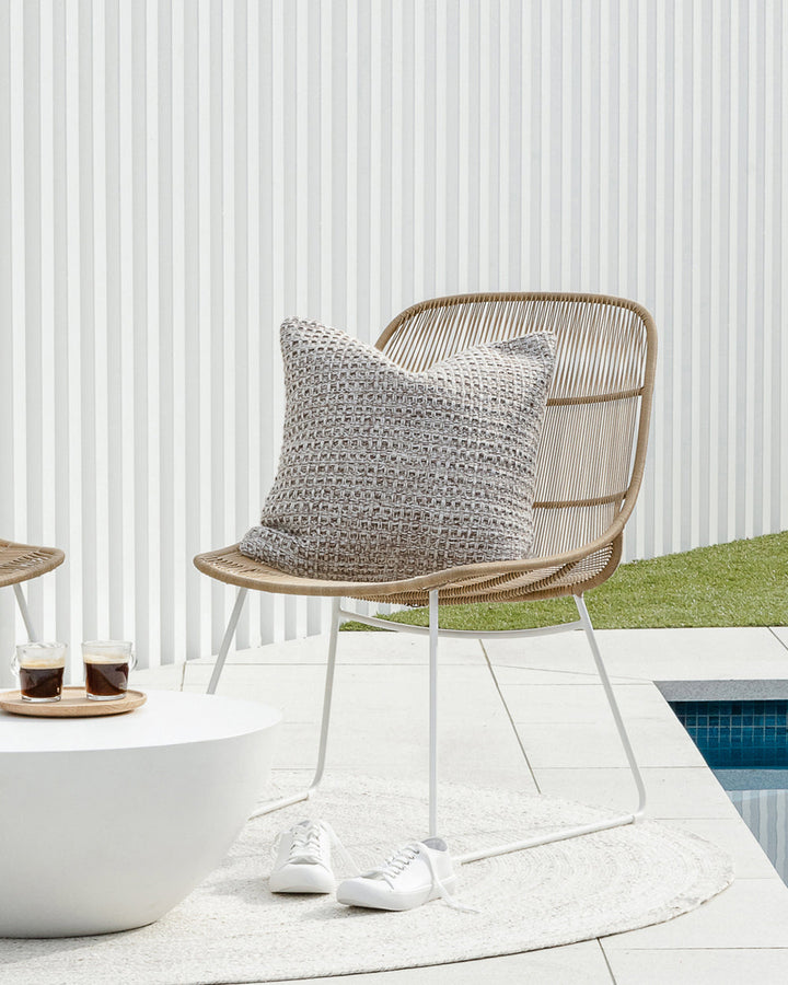 Elton Cushion A natural, artisan aesthetic is reflected in the stunning design of this outdoor cushion. Handwoven from soft PET yarn (derived from recycled plastic bottles), the Elton features a classic basketweave texture in speckled hues of cocoa, ecru