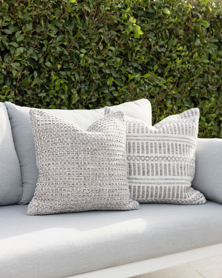 Elton Cushion A natural, artisan aesthetic is reflected in the stunning design of this outdoor cushion. Handwoven from soft PET yarn (derived from recycled plastic bottles), the Elton features a classic basketweave texture in speckled hues of cocoa, ecru