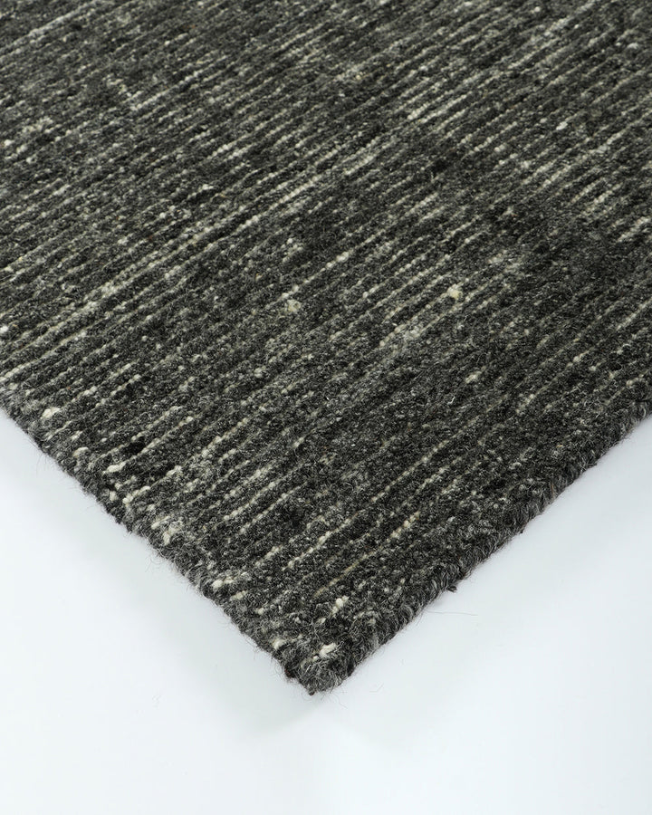 Emmett Floor Rug An understated floor rug that is both simple and luxurious. The Emmett is hand-knotted from 100% wool, creating a soft minimal pile. Featuring a fine linear pattern with a lighter base tone, this floor rug is perfect for crafting a refine