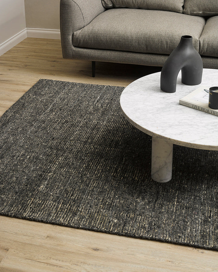 Emmett Floor Rug An understated floor rug that is both simple and luxurious. The Emmett is hand-knotted from 100% wool, creating a soft minimal pile. Featuring a fine linear pattern with a lighter base tone, this floor rug is perfect for crafting a refine