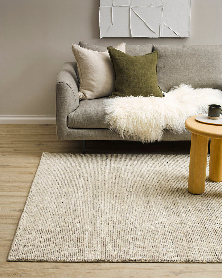 Emmett Floor Rug An understated floor rug that is both simple and luxurious. The Emmett is hand-knotted from 100% wool, creating a soft minimal pile. Featuring a fine linear pattern with a lighter base tone, this floor rug is perfect for crafting a refine