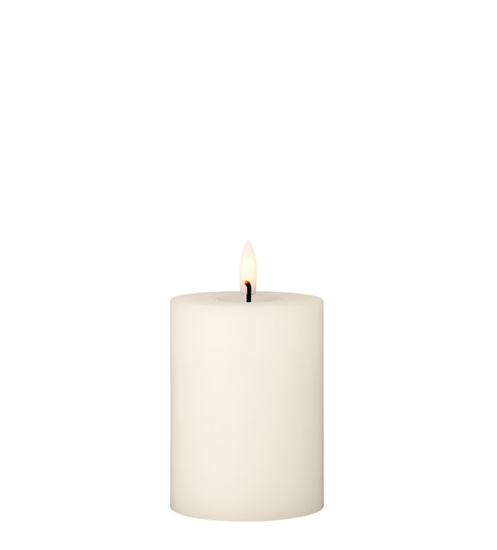 Ester & Erik LED pillar candle with lifelike glow, perfect for elegant decor in 12 stunning colors.