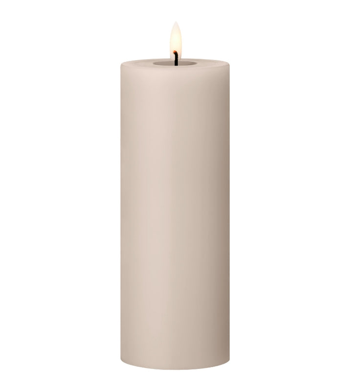 Ester & Erik LED pillar candle in soft beige with lifelike glow, perfect for enhancing any space or occasion.
