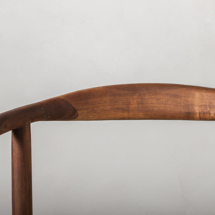 Essence Dining Chair Fabric/Walnut curved walnut wood frame detail showcasing organic materiality.
