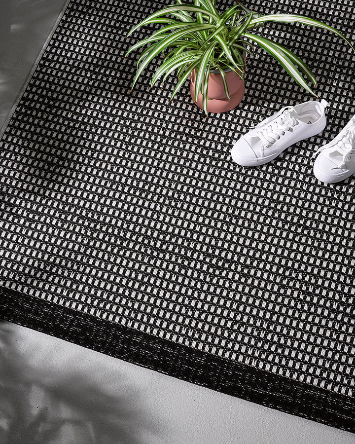 Flaxseed Floor Rug Bring a well-appointed feel to your outdoors with the basket-weave texture of our Flaxseed outdoor rug. The monochrome palette makes this piece easy to pair with flooring, furniture, and soft furnishings, while the flatweave design is v