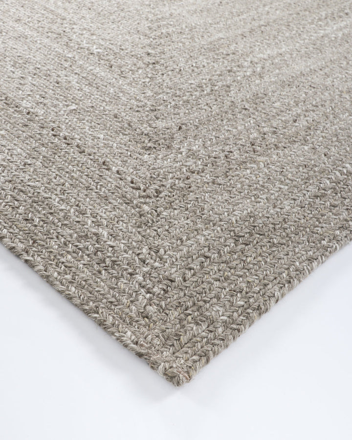 Flinders Floor Rug Indulge in the beauty of understated design. Flinders features a gently mottled texture, handbraided into a subtle linear pattern with mitre point corners. Handcrafted by skilled artisans, the sustainable PET composition is soft and dur