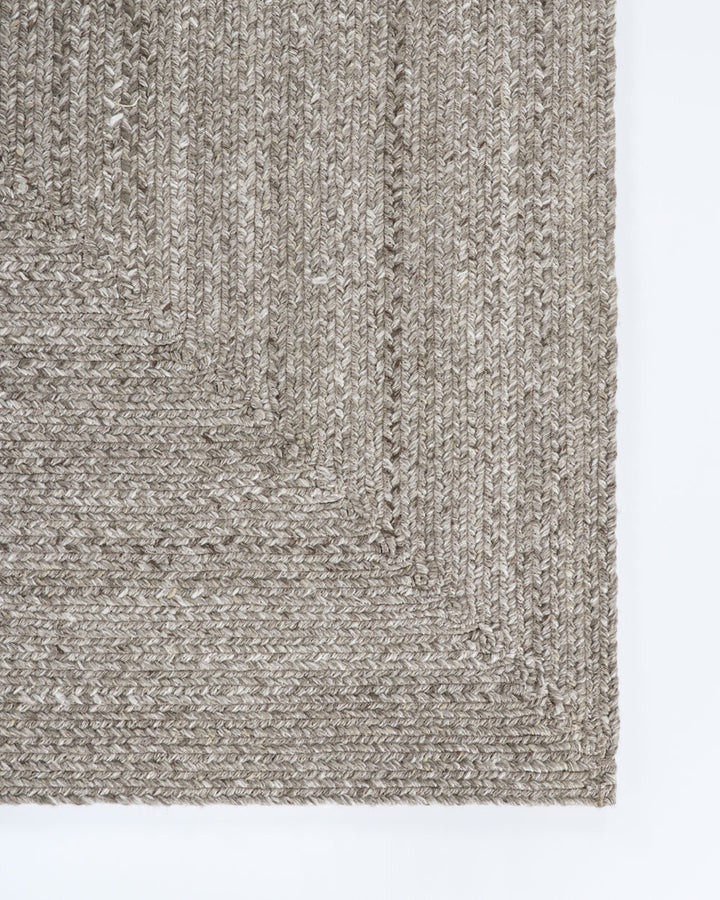 Flinders Floor Rug Indulge in the beauty of understated design. Flinders features a gently mottled texture, handbraided into a subtle linear pattern with mitre point corners. Handcrafted by skilled artisans, the sustainable PET composition is soft and dur