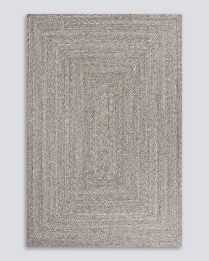 Flinders Floor Rug Indulge in the beauty of understated design. Flinders features a gently mottled texture, handbraided into a subtle linear pattern with mitre point corners. Handcrafted by skilled artisans, the sustainable PET composition is soft and dur