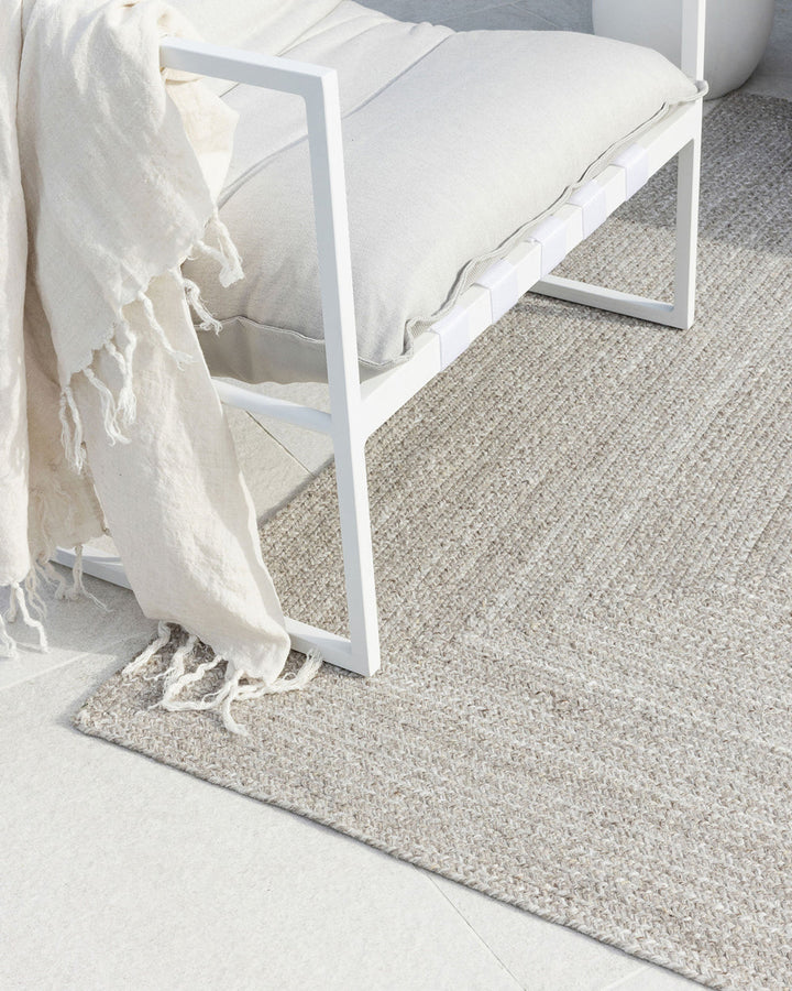 Flinders Floor Rug Indulge in the beauty of understated design. Flinders features a gently mottled texture, handbraided into a subtle linear pattern with mitre point corners. Handcrafted by skilled artisans, the sustainable PET composition is soft and dur