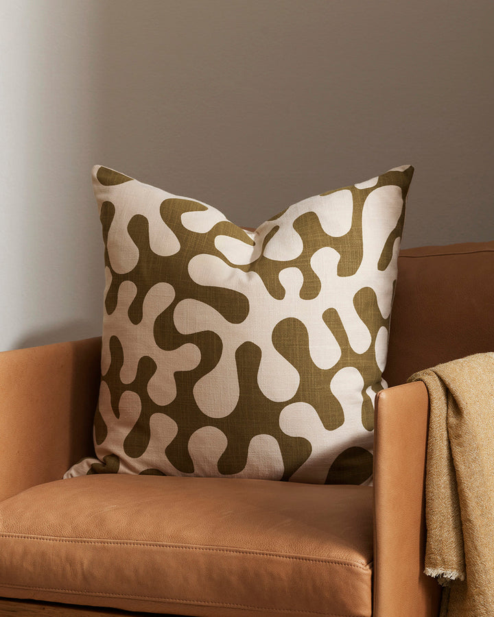 Forbici Cushion Inspired by 1950's jungle forms and Matisse, Forbici is a bold, confident design, with simplified leaf motifs screen-printed onto an ecru ground. Captured in a rich olive tone, this expressive piece is perfect for creating an interior brim