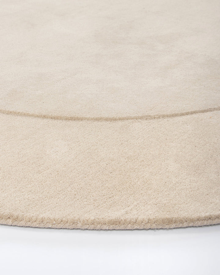 Form Floor Rug Add a stunning focal point to your space with the elegantly curved Form rug. Handtufted from 100% wool, the dense underfoot texture conveys a sense of luxury, while the cut-pile border adds dimension to the creamy, uniform base. Australian