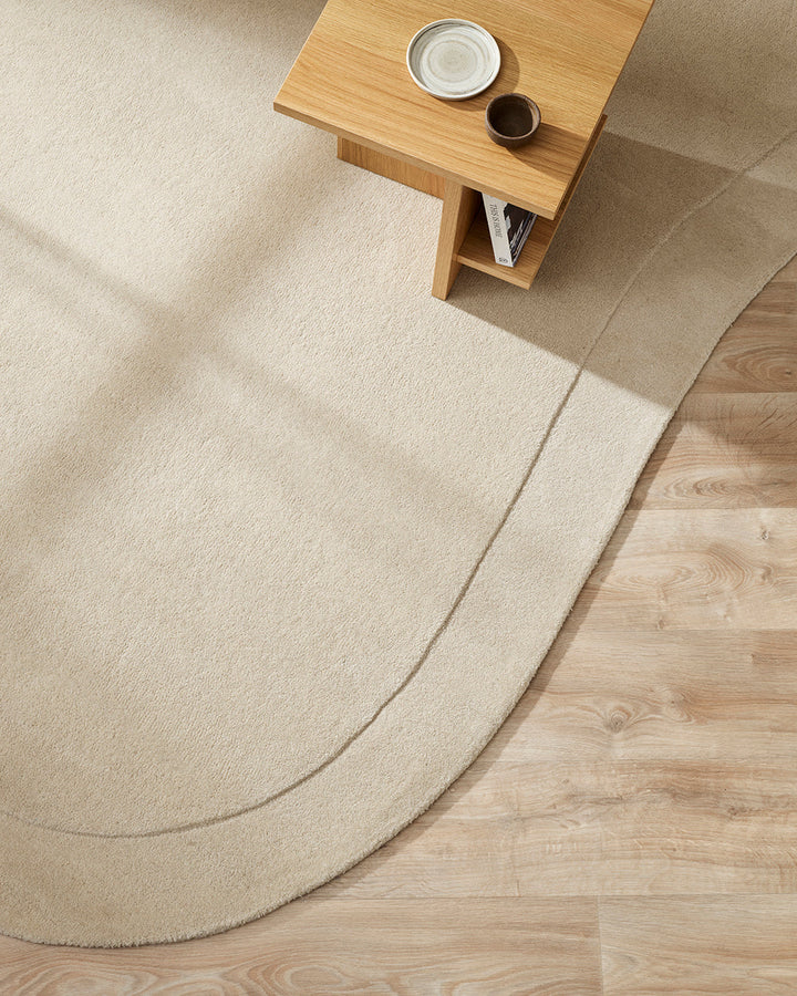 Form Floor Rug Add a stunning focal point to your space with the elegantly curved Form rug. Handtufted from 100% wool, the dense underfoot texture conveys a sense of luxury, while the cut-pile border adds dimension to the creamy, uniform base. Australian