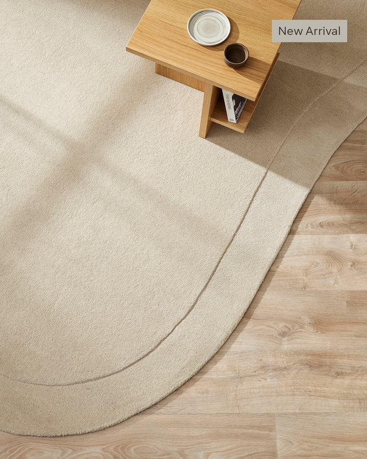 Form Floor Rug Add a stunning focal point to your space with the elegantly curved Form rug. Handtufted from 100% wool, the dense underfoot texture conveys a sense of luxury, while the cut-pile border adds dimension to the creamy, uniform base. Australian