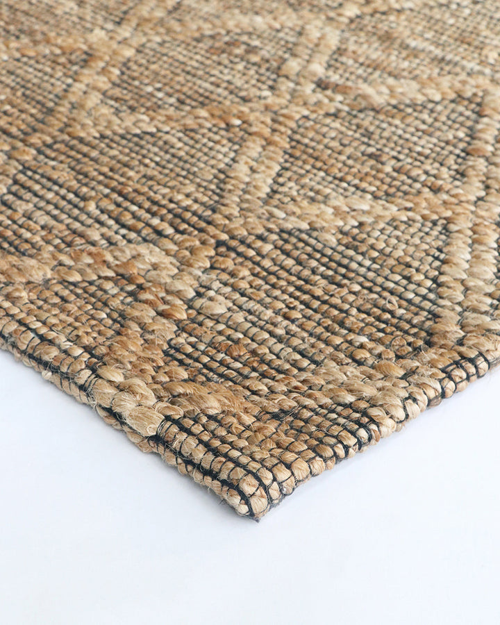 Genoa Floor Rug Create a welcoming space with the beauty of natural fibres. Inspired by dry landscapes, the handwoven texture and earthy tones of this piece bring a well-travelled feel to your space. Crafted from natural hemp fibre with black cotton detai