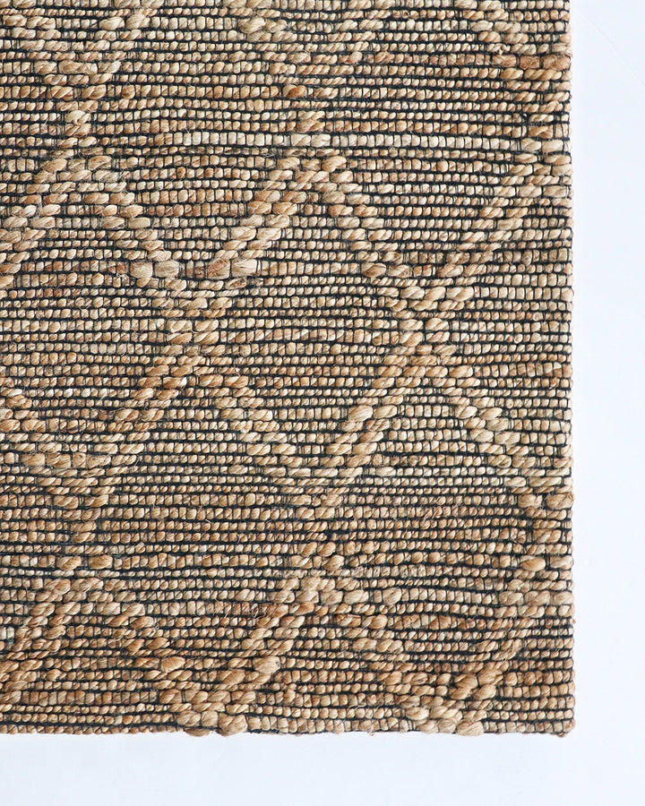 Genoa Floor Rug Create a welcoming space with the beauty of natural fibres. Inspired by dry landscapes, the handwoven texture and earthy tones of this piece bring a well-travelled feel to your space. Crafted from natural hemp fibre with black cotton detai