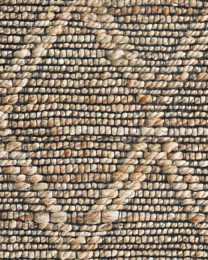 Genoa Floor Rug Create a welcoming space with the beauty of natural fibres. Inspired by dry landscapes, the handwoven texture and earthy tones of this piece bring a well-travelled feel to your space. Crafted from natural hemp fibre with black cotton detai