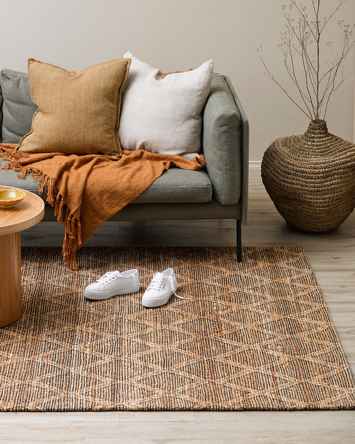 Genoa Floor Rug Create a welcoming space with the beauty of natural fibres. Inspired by dry landscapes, the handwoven texture and earthy tones of this piece bring a well-travelled feel to your space. Crafted from natural hemp fibre with black cotton detai