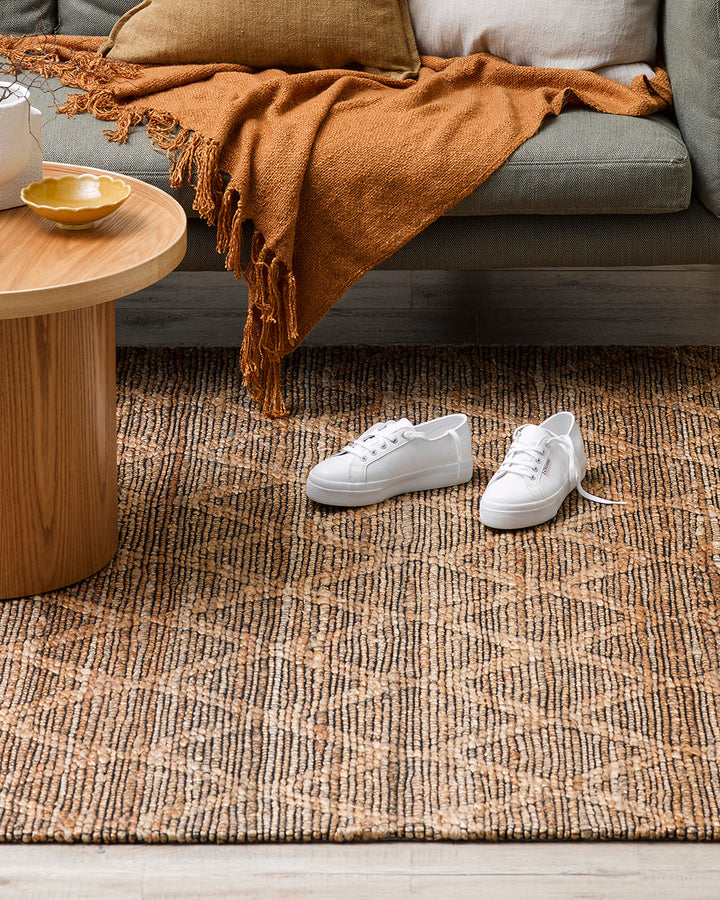 Genoa Floor Rug Create a welcoming space with the beauty of natural fibres. Inspired by dry landscapes, the handwoven texture and earthy tones of this piece bring a well-travelled feel to your space. Crafted from natural hemp fibre with black cotton detai