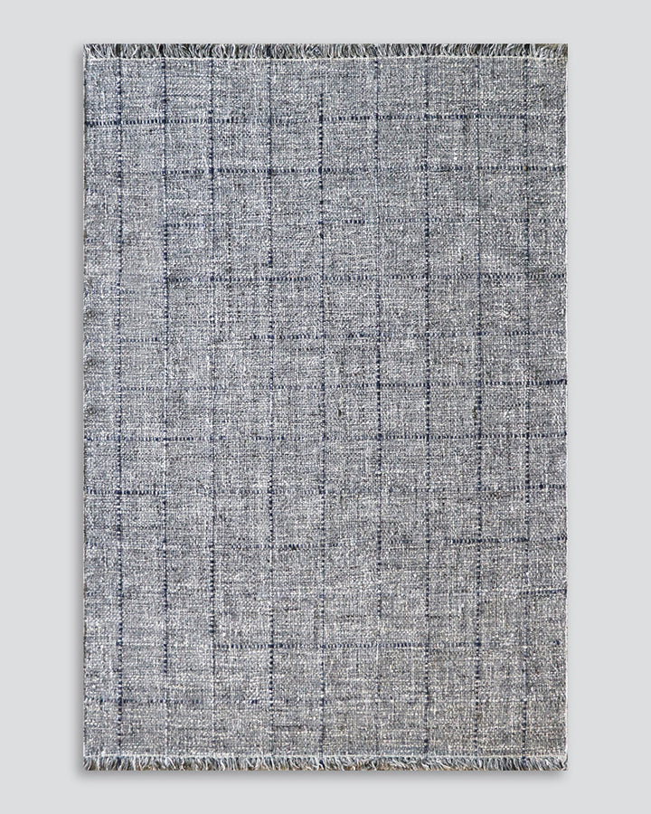 Gibson Floor Rug Handwoven by skilled artisans, our Gibson floor rug is crafted from a rich blend of wool and viscose. Tonal fibres are carefully interwoven with flecks of darker and lighter colourways, forming a subtle plaid pattern. The flatweave struct