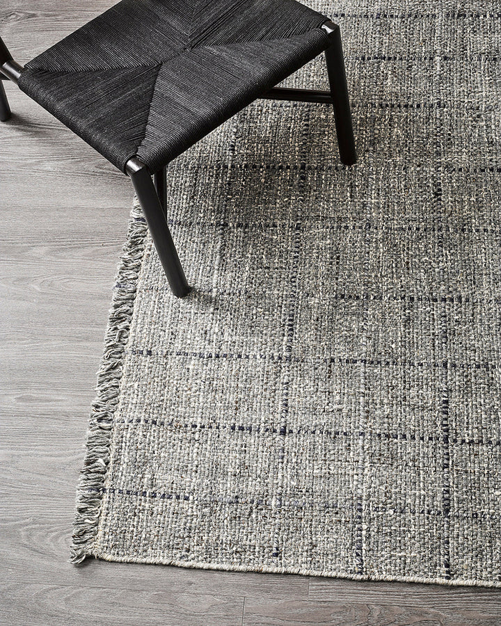 Gibson Floor Rug Handwoven by skilled artisans, our Gibson floor rug is crafted from a rich blend of wool and viscose. Tonal fibres are carefully interwoven with flecks of darker and lighter colourways, forming a subtle plaid pattern. The flatweave struct