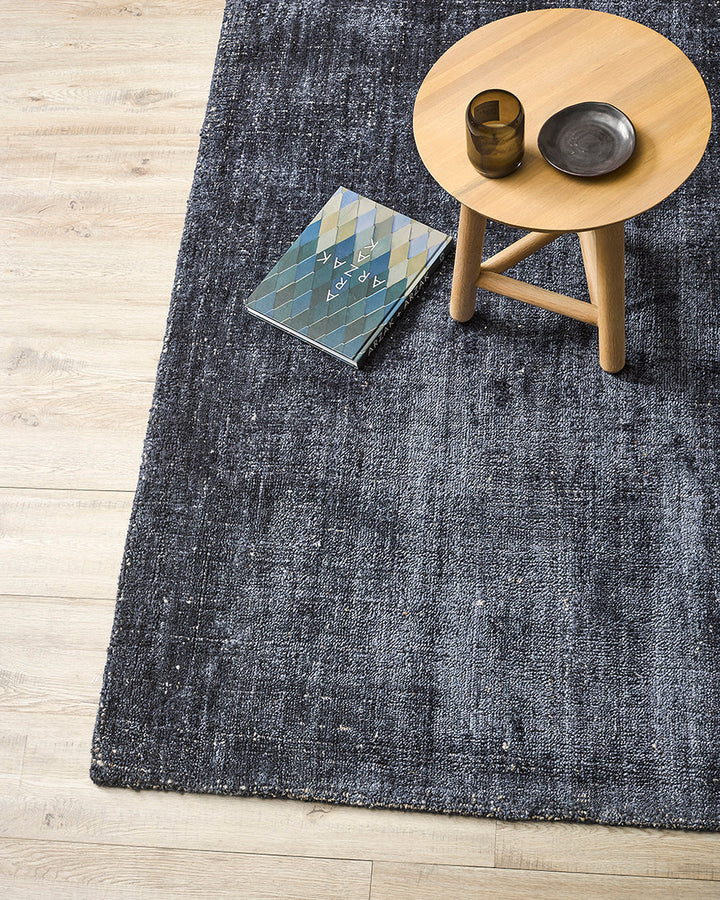 Gratus Floor Rug Indulge in the subtle sheen, rich fibre, and silky underfoot texture of Gratus. Handcrafted from a stunning blend of bamboo silk and wool, the muted gold colouring is complemented by a darker base undertone. Beautifully soft, the gentle l