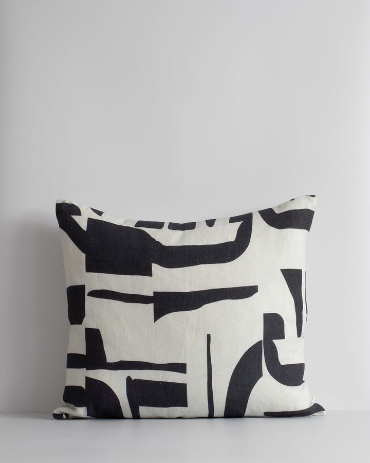 Isla Cushion Inspired by modernist forms, the design here is confident with off-beat shapes arranged on a pure linen base. Hand-painted by our in-house team, the navy-black and ecru tones form an elegant and expressive cushion â€“ perfect for crafting a c