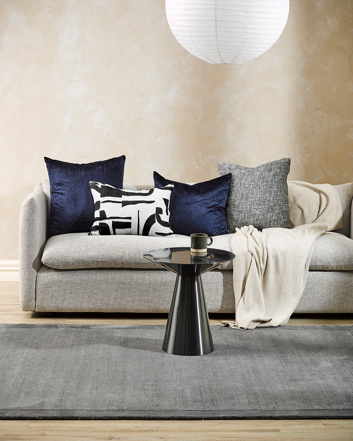 Isla Cushion Inspired by modernist forms, the design here is confident with off-beat shapes arranged on a pure linen base. Hand-painted by our in-house team, the navy-black and ecru tones form an elegant and expressive cushion â€“ perfect for crafting a c