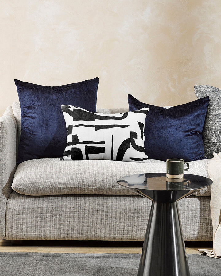 Isla Cushion Inspired by modernist forms, the design here is confident with off-beat shapes arranged on a pure linen base. Hand-painted by our in-house team, the navy-black and ecru tones form an elegant and expressive cushion â€“ perfect for crafting a c