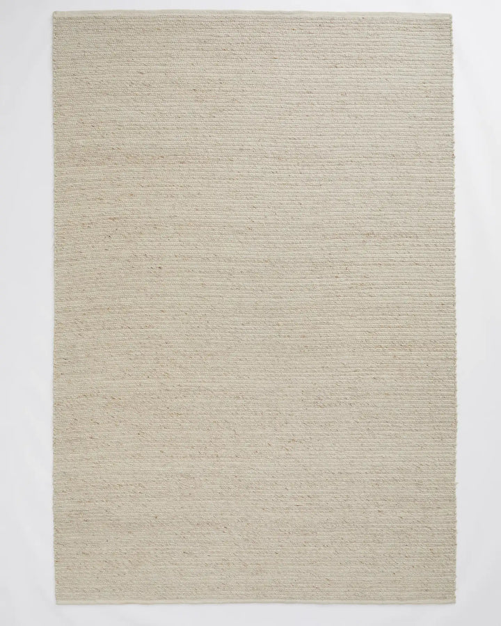 Andes Sandstorm - Hand-Woven Textured Floor Rug Discover the Andes Sandstorm rug, a stylish hand-woven floor piece perfect for coastal decor with warm cream tones and natural textures.
