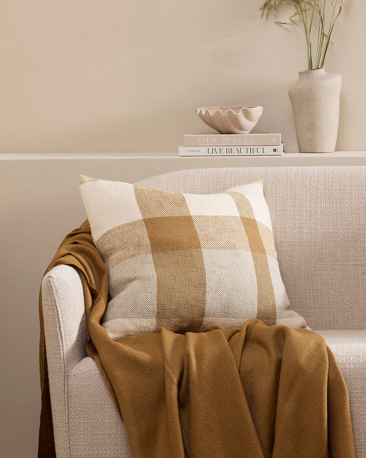 Jefferson Cushion Country charm is reinterpreted for urban living in the contemporary design of the Jefferson. Tones of cumin, ivory and tobacco are woven into an offset, oversized plaid design, embodying the modern country trend. Crafted from a thick cot