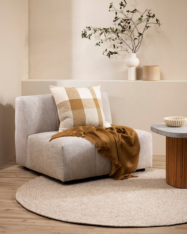 Jefferson Cushion Country charm is reinterpreted for urban living in the contemporary design of the Jefferson. Tones of cumin, ivory and tobacco are woven into an offset, oversized plaid design, embodying the modern country trend. Crafted from a thick cot