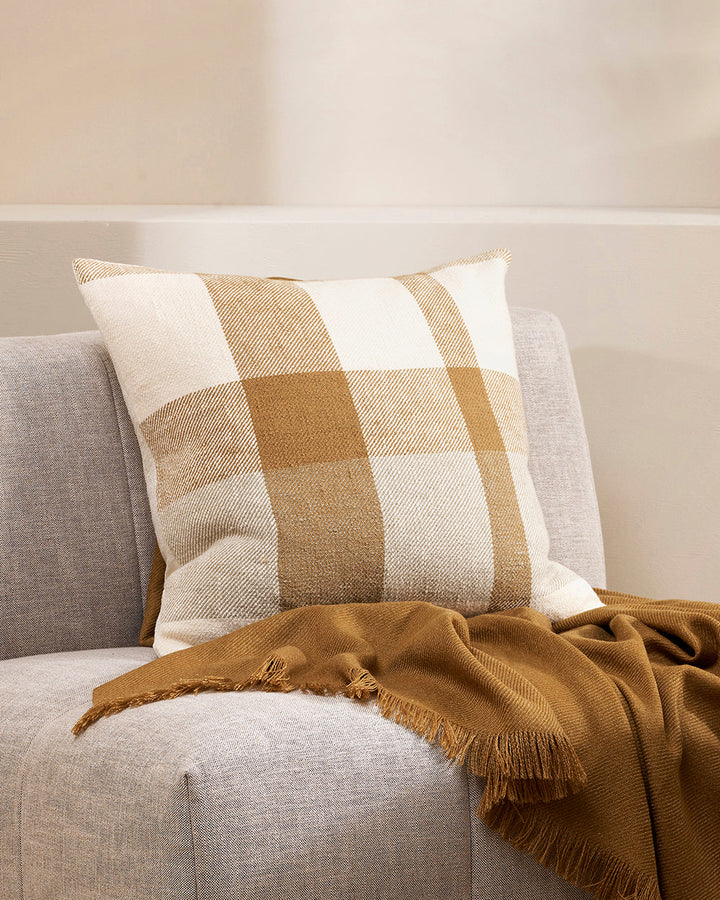 Jefferson Cushion Country charm is reinterpreted for urban living in the contemporary design of the Jefferson. Tones of cumin, ivory and tobacco are woven into an offset, oversized plaid design, embodying the modern country trend. Crafted from a thick cot