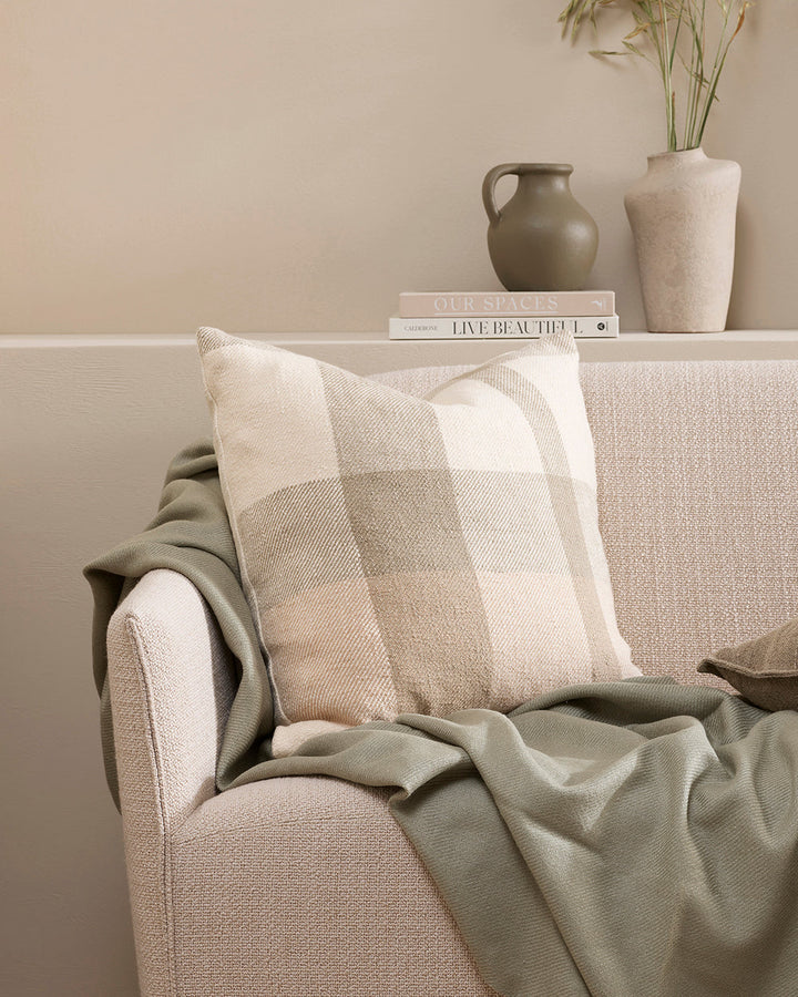 Jefferson Cushion Country charm is reinterpreted for urban living in the contemporary design of the Jefferson. Tones of cumin, ivory and tobacco are woven into an offset, oversized plaid design, embodying the modern country trend. Crafted from a thick cot