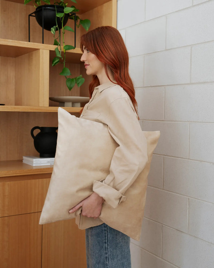 Ava Nougat Cushion - Luxurious Velvet Comfort Discover the Ava Nougat cushion in creamy beige, a luxurious addition to your space with over 20 colorways and a soft velvet-like texture.